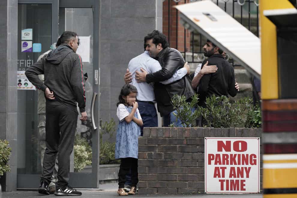 People leave the Sheffield Metropolitan Hotel, where a five-year-old Afghan refugee died after he fell from a window (Peter Byrne/PA)