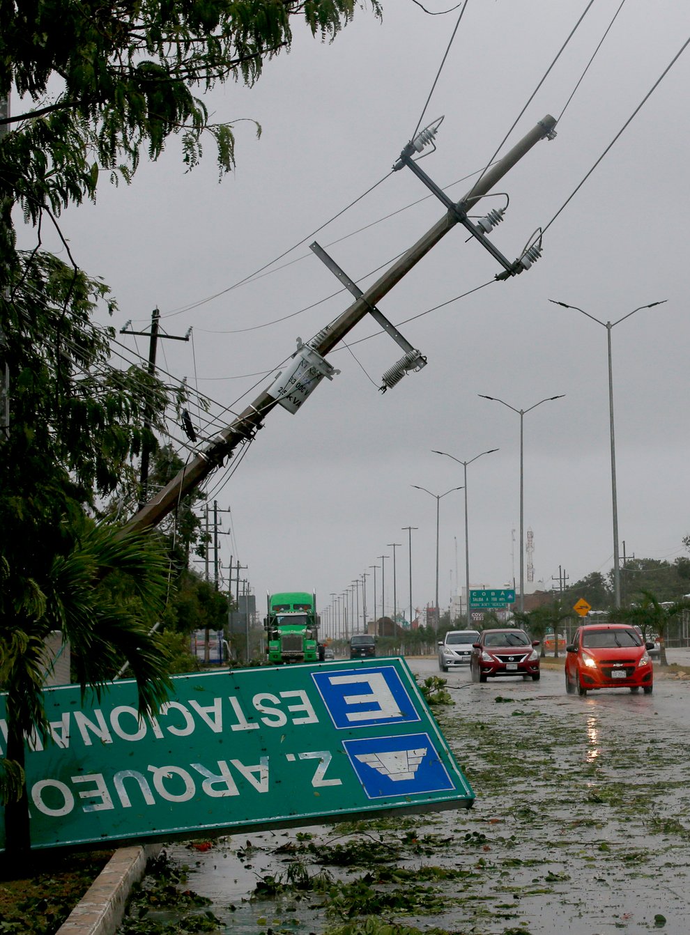 A road sign brought down by the winds of Hurricane Grace lays on the side of the highway in Tulum, Quintana Roo state, Mexico, Thursday, Aug. 19, 2021. The Category 1 storm made landfall at 4:45 a.m., just south of the ancient Mayan temples of Tulum, pelting the Caribbean coast with heavy rain and pushing a dangerous storm surge. (AP Photo/Marco Ugarte)