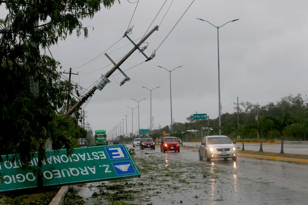 A road sign brought down by the winds of Hurricane Grace lays on the side of the highway in Tulum, Quintana Roo state, Mexico, Thursday, Aug. 19, 2021. The Category 1 storm made landfall at 4:45 a.m., just south of the ancient Mayan temples of Tulum, pelting the Caribbean coast with heavy rain and pushing a dangerous storm surge. (AP Photo/Marco Ugarte)