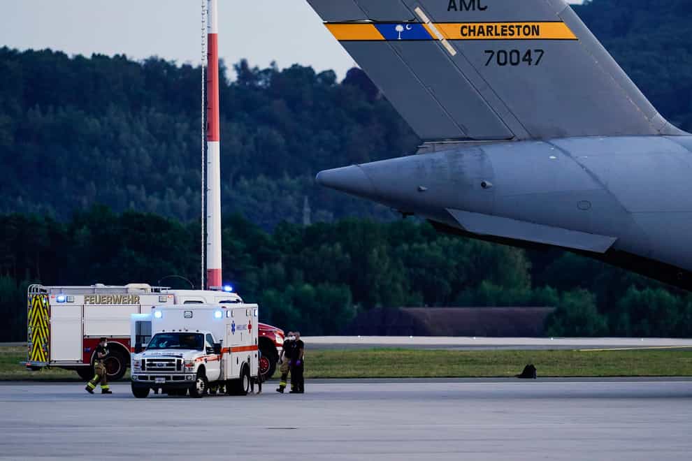 An ambulance stands next to a C-17 transport plane carrying people from Afghanistan at Ramstein Air Base in Germany (Uwe Anspach/dpa/AP)