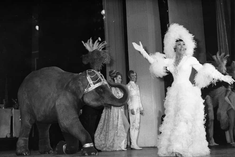Josephine Baker appears on stage with a young elephant during a 1968 gala premiere at the Olympia Theatre in Paris (AP)