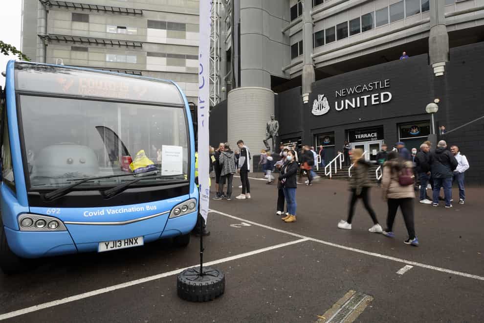 A Covid-19 vaccination bus outside the St James’ Park football stadium in Newcastle (Owen Humphreys/PA)