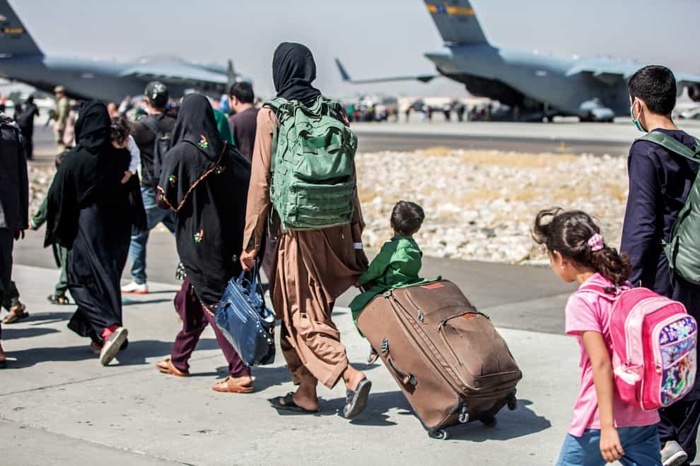 Families walk towards their flight during ongoing evacuations at Hamid Karzai International Airport, Kabul, Afghanistan (Sgt Samuel Ruiz/US Marine Corps via AP)