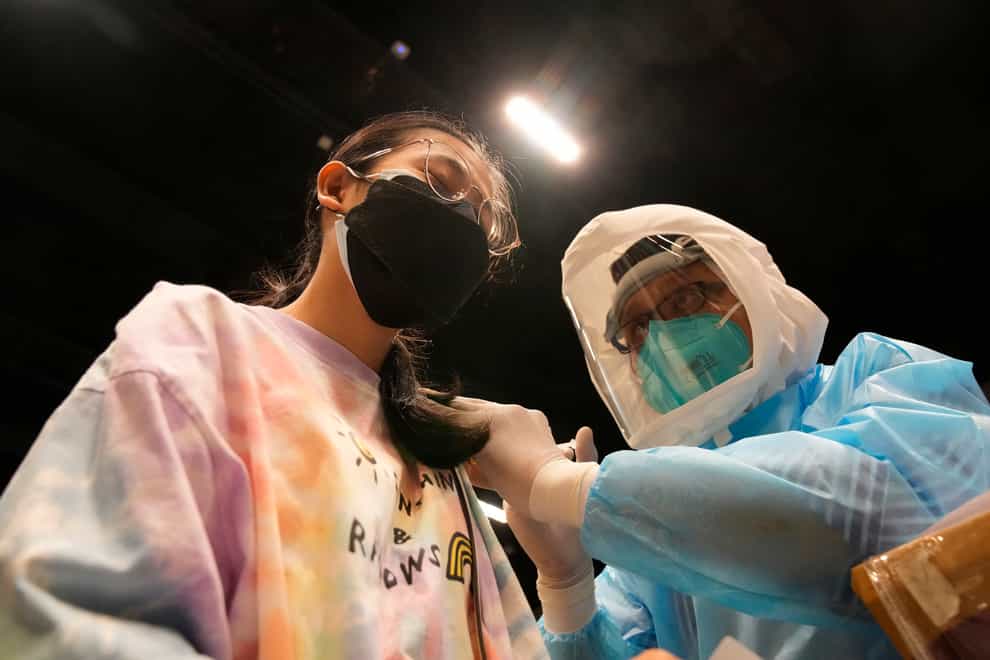 A health worker administers a dose of Covid-19 vaccine to a woman in Bangkok, Thailand (Sakchai Lalit/AP)