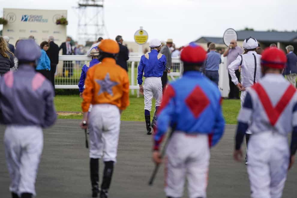 Jockeys will continue to ride at one meeting per day (Alan Crowhurst/PA)