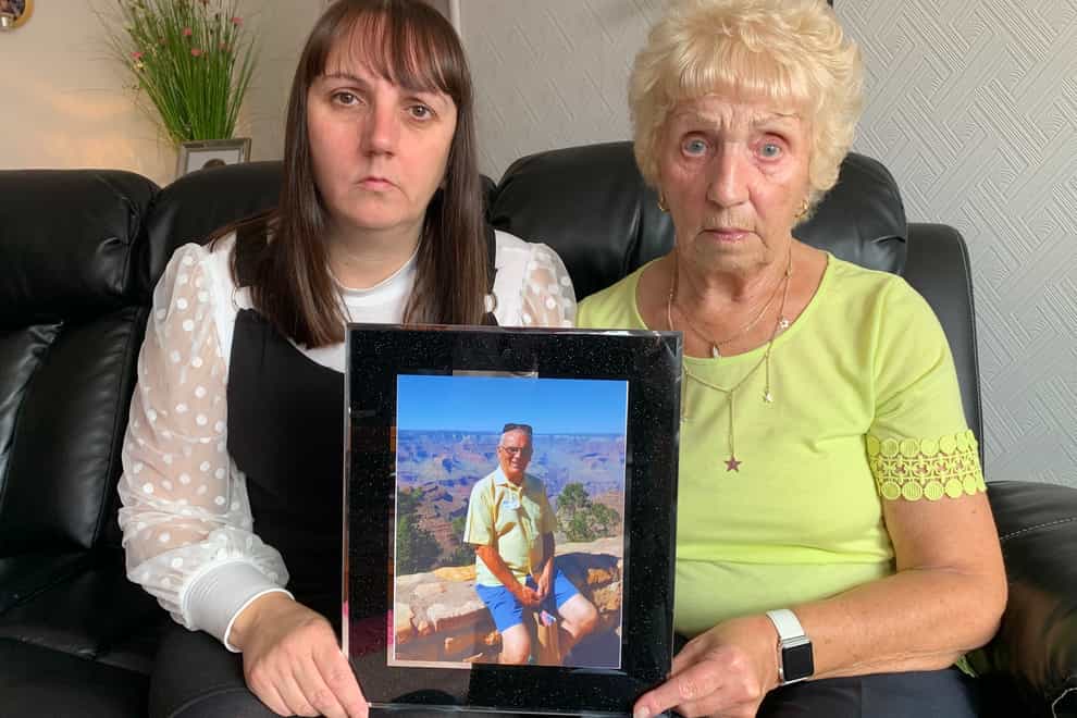 Laura and Mary Alexander with a picture of Ronnie, who froze to death in 2018 (Digby Brown/PA)