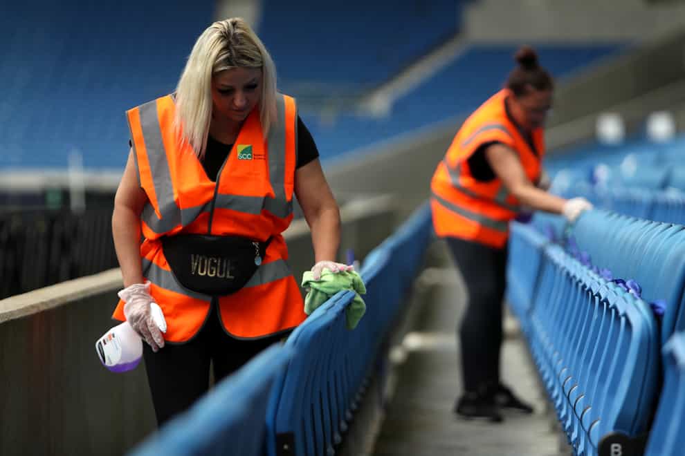Ground staff disinfect seats ahead of a Premier League match at the Amex Stadium in Brighton (Kieran Cleeves/PA)