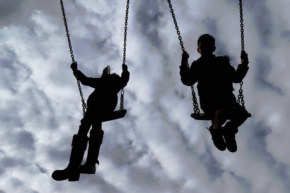 Children enjoy playing on swings in a park near Ashford, Kent (Gareth Fuller/PA)