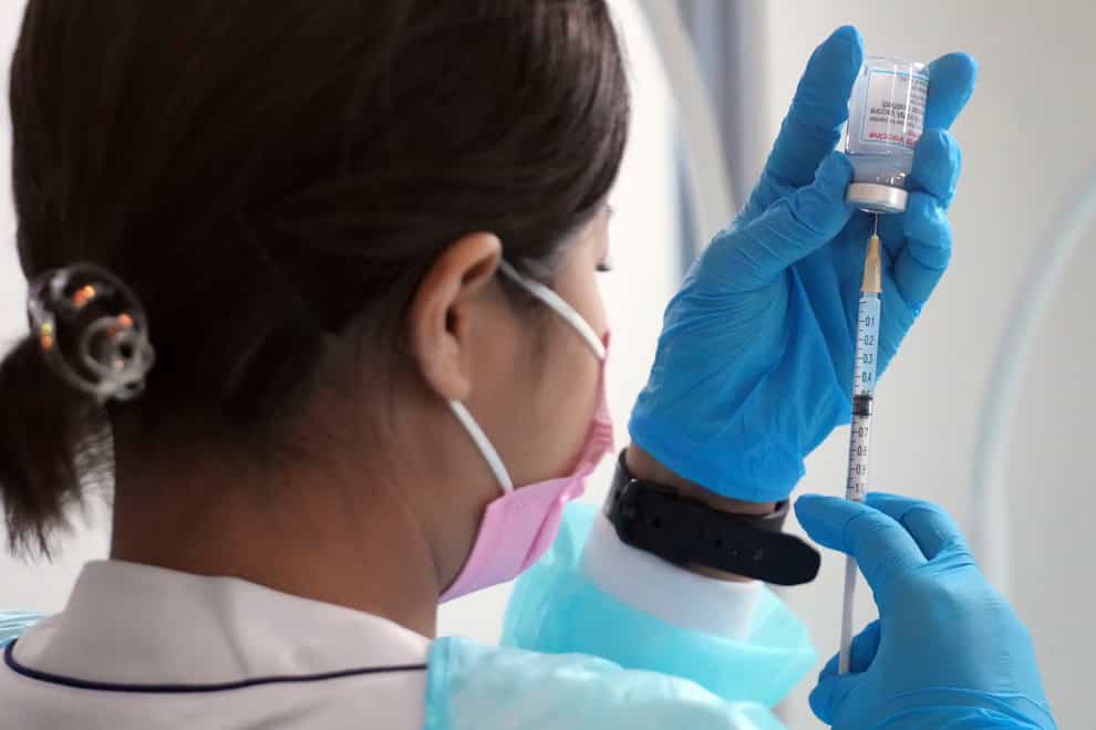 A health worker prepares a dose of the Moderna Covid-19 vaccine (Eugene Hoshiko/AP)