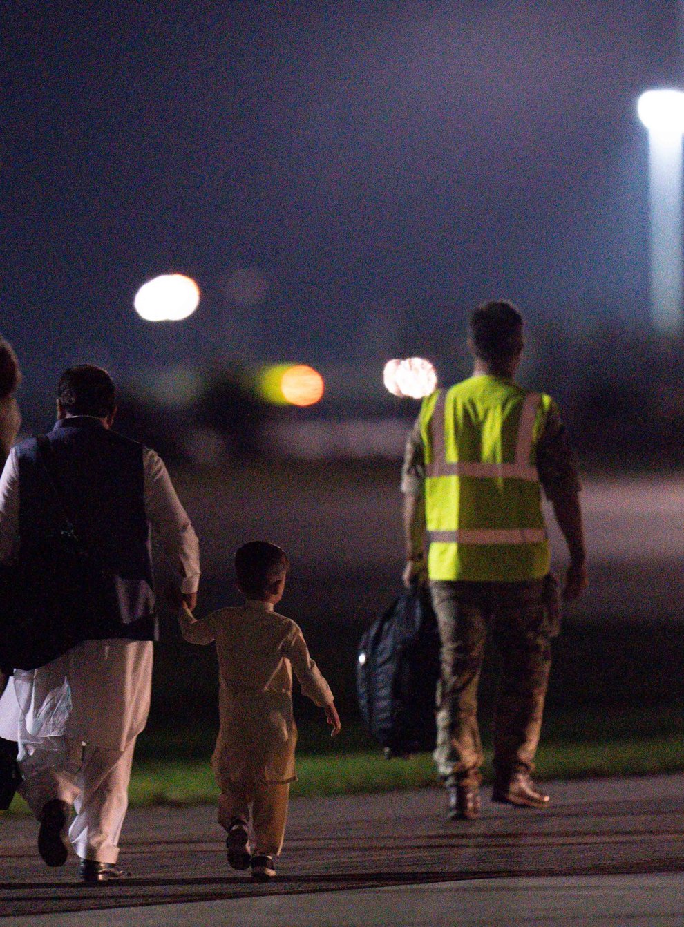 British nationals and Afghan evacuees depart a flight from Afghanistan at RAF Brize Norton (Jacob King/PA)
