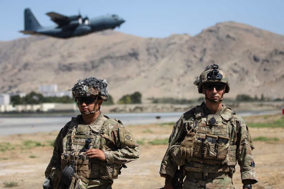 Two paratroopers of the 82nd Airborne Division stand guard outside Kabul airport as a plane departs (Department of Defence via AP)