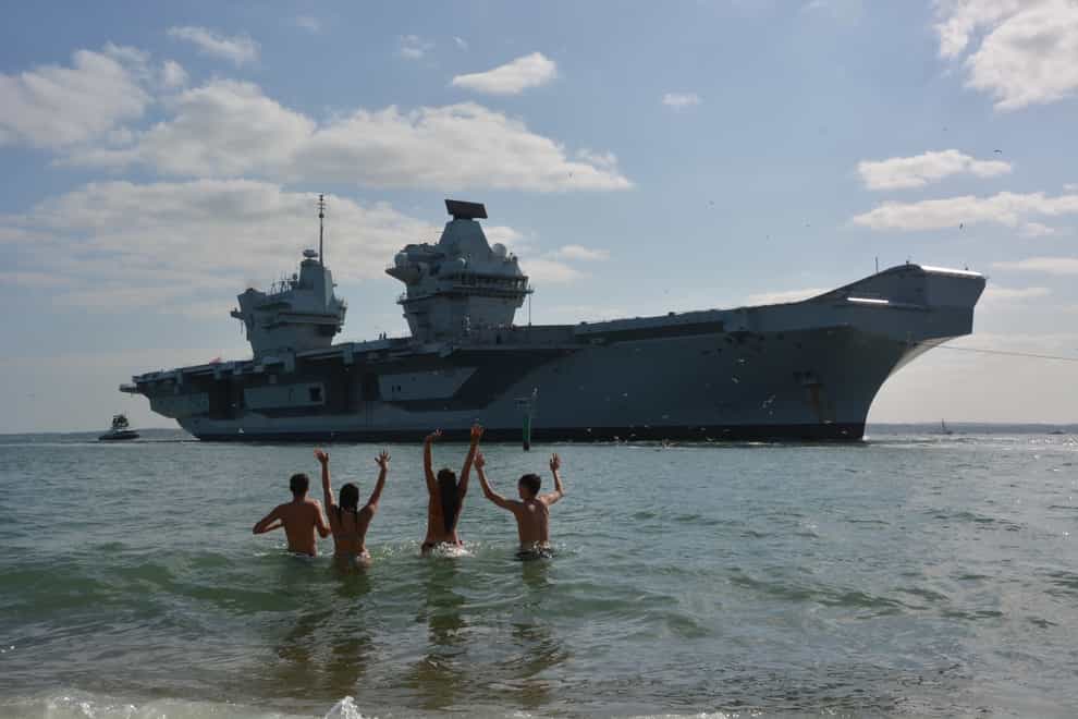 Bathers welcome home the HMS Prince of Wales aircraft carrier to Portsmouth (Ben Mitchell/PA)