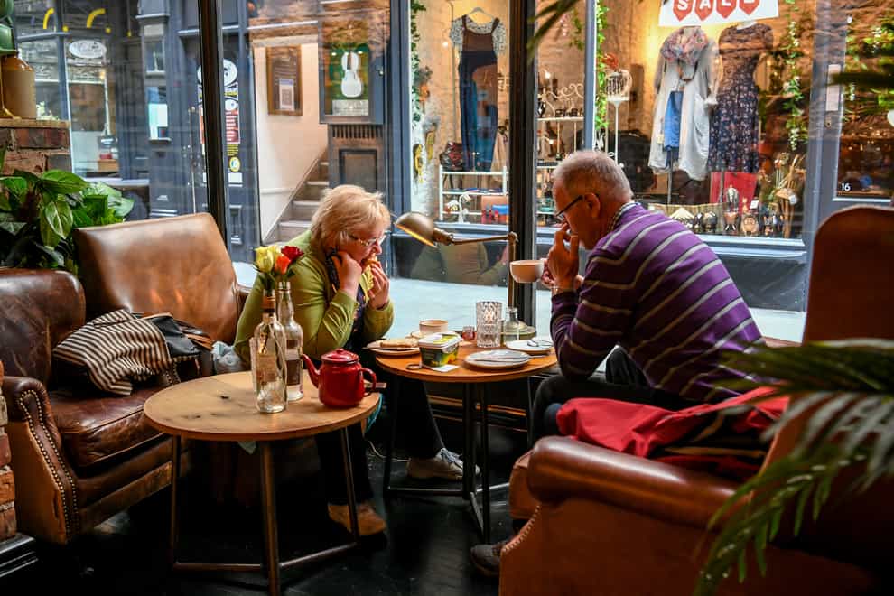 People enjoy a breakfast and coffee in Cardiff (PA)