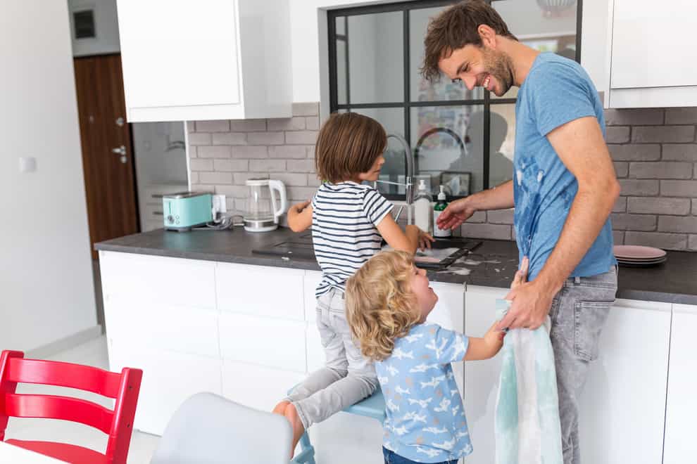 Children and father in kitchen (Alamy/PA)