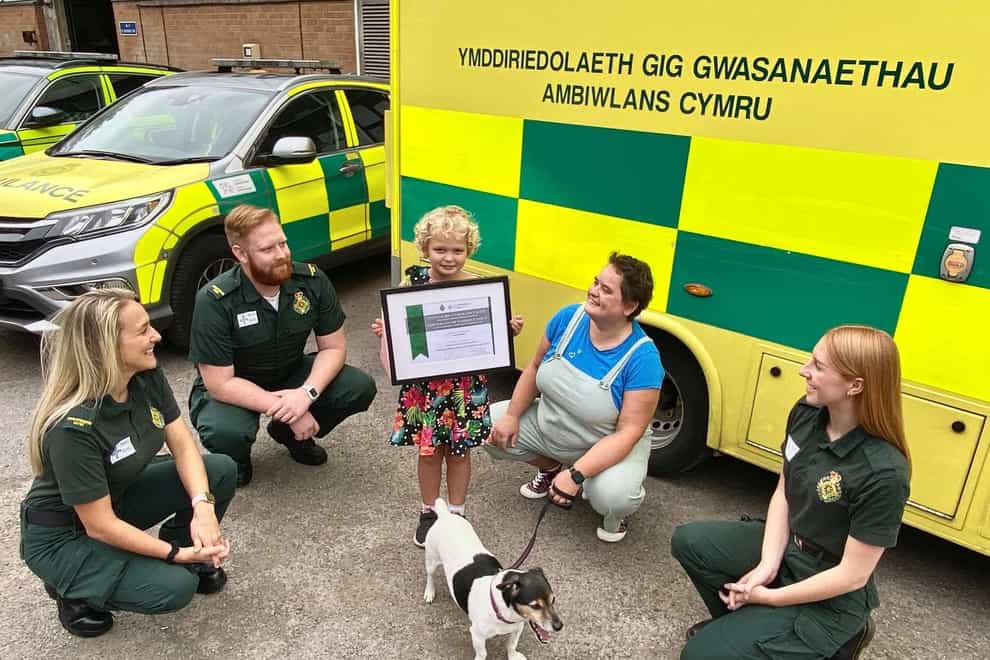 (from left) Paramedics Harriett Thomas and Will Jones, Isla, her mother Katherine Holifield, dog Roly and call handler Madison Vickery (Welsh Ambulances Services NHS Trust/PA)
