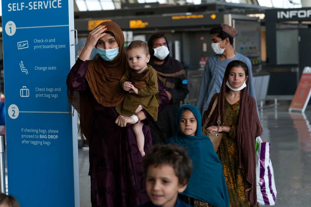 Families evacuated from Kabul arrive at Washington Dulles International Airport in the US (Jose Luis Magana/AP)