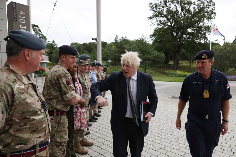 Prime Minister Boris Johnson walks with Vice Admiral Ben Key (right) as he greets military personnel (Adrian Dennis/PA)