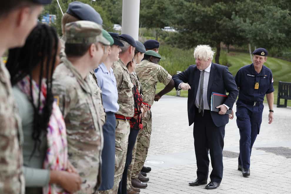 Prime Minister Boris Johnson is greeted by military personnel (Adrian Dennis/PA)