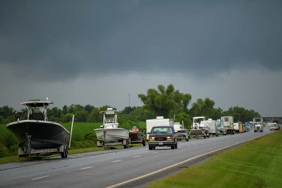 Boats, trailers and RVs line Louisiana Highway 46 after owners moved them to be inside the levee protection zone before Hurricane Ida makes landfall in St Bernard Parish, Louisiana (Matthew Hinton/AP)