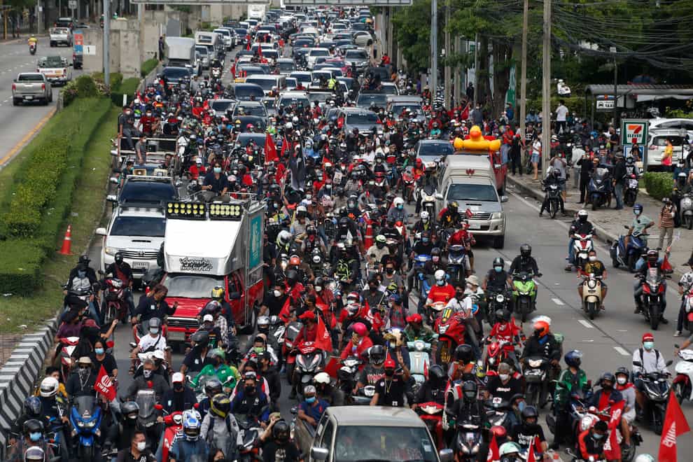 Anti-government protesters block the road with cars and motorcycles as a part of their “car mob” demonstrations along several roads in Bangkok, Thailand, Sunday, Aug. 29, 2021. A long line of cars, trucks and motorbikes wended its way Sunday through the Thai capital Bangkok in a mobile protest against the government of Prime Minister Prayuth Chan-ocha. The protesters on wheels hope their nonviolent action, dubbed a “car mob,” can help force the ouster of Prayuth, whom they accuse of botching the campaign against the coronavirus. (AP Photo/Anuthep Cheysakron)