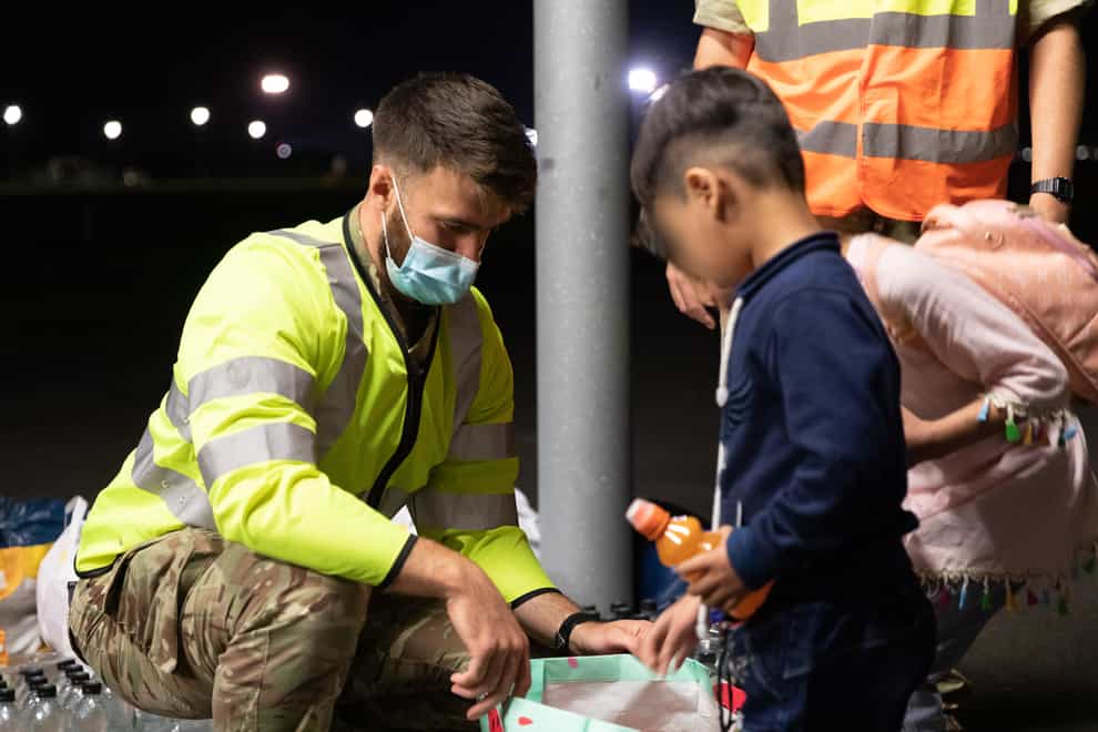 Handout photo issued by the Ministry of Defence (MoD) of military personnel handing out food, drink, toys, and blankets during Op PITTING at RAF Brize Norton. (Cpl Will Drummee RAF/MOD/Crown copyright/PA)
