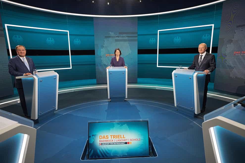 Candidates for chancellor from left, Armin Laschet, Annalena Baerbock and Olaf Scholz stand before the broadcast in the TV studio in Berlin (Michael Kappeler/AP)
