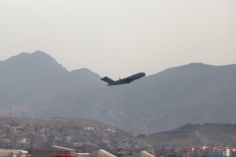 A US military aircraft takes off from the Hamid Karzai International Airport in Kabul, Afghanistan (Wali Sabawoon/AP)