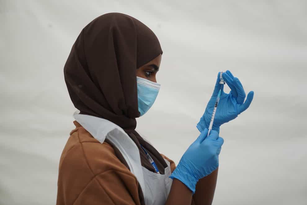 An NHS worker prepares a Covid-19 jab at a pop-up vaccination centre in Langdon Park, Poplar, east London (Kirsty O’Connor/PA)