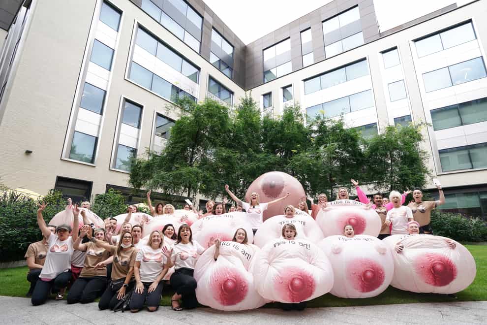Protesters wearing inflatable breasts stand outside Facebook’s headquarters in central London, to complain about the social media giant’s images algorithm (PA)