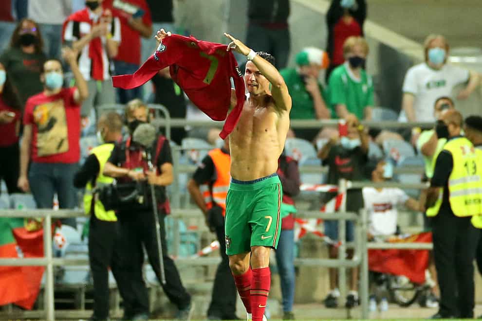 Portugal’s Cristiano Ronaldo holds up his shirt to to the fans after scoring his sides second goal during the 2022 FIFA World Cup Qualifying match at the Estadio Algarve, Portugal. Picture date: Wednesday September 1, 2021.