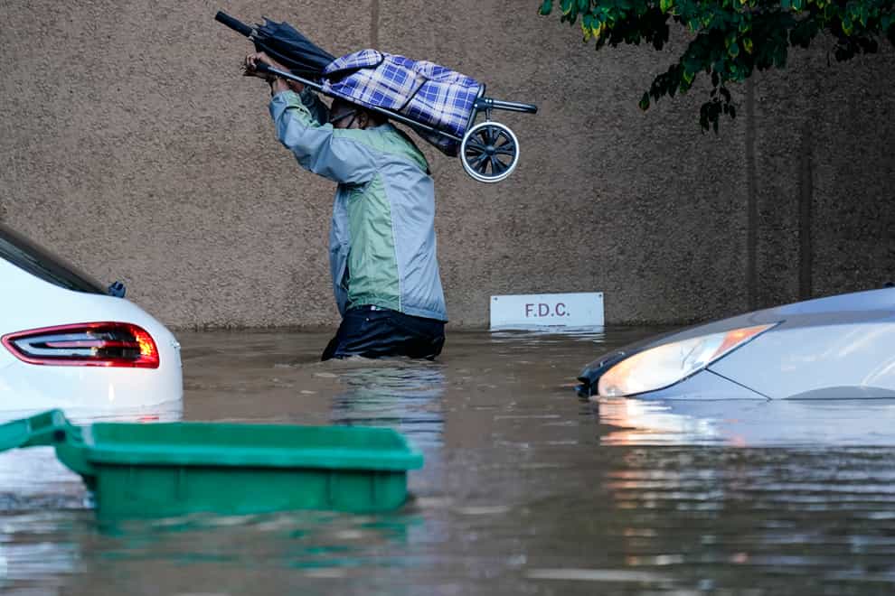A person walks in floodwaters in Philadelphia (AP Photo/Matt Rourke)