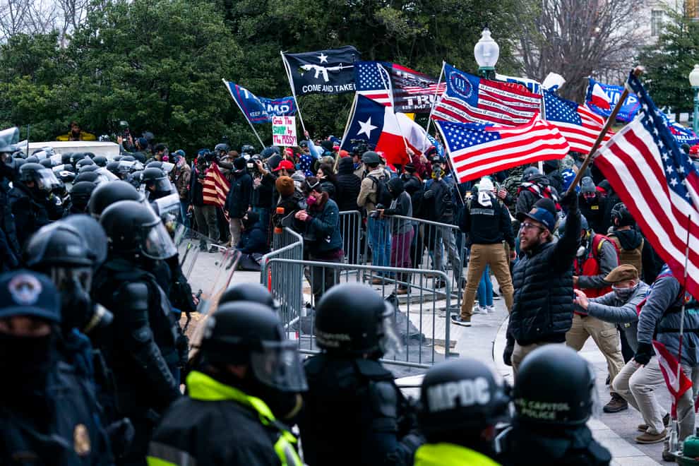 Insurrections loyal to President Donald Trump confront police officers outside the Capitol in Washington (AP Photo/Manuel Balce Ceneta, File)