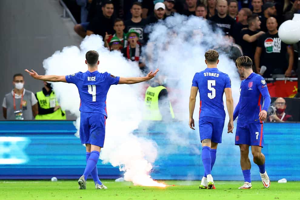 England’s Declan Rice gestures towards the fans as a flare is thrown on to the pitch (Attila Trenka/PA).
