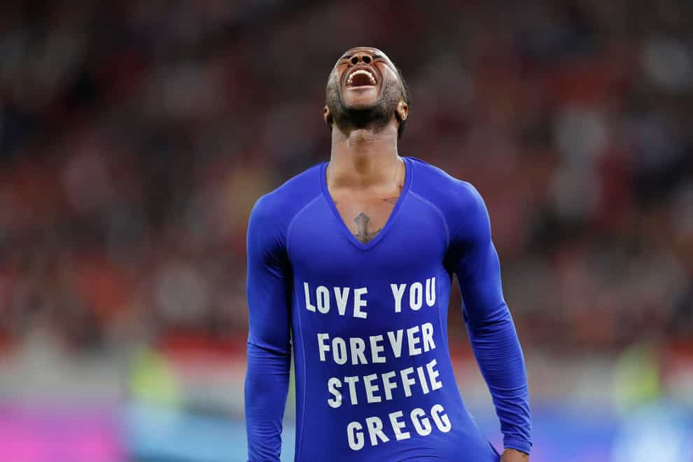 England’s Raheem Sterling takes off his jersey to pay tribute to Steffie Gregg (Laszlo Balogh/AP)