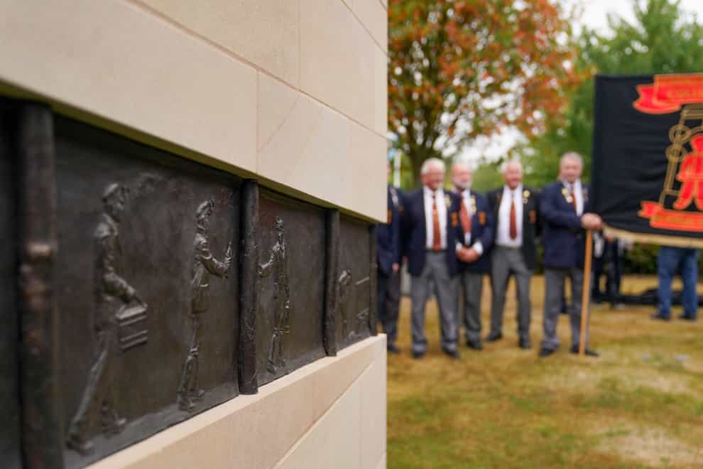 Members of the Lea Hall & Brereton Collieries Memorial Society observe the National Miners’ Memorial (PA)
