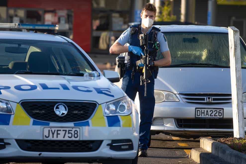 Armed police stand outside a supermarket in Auckland, New Zealand after a man stabbed and injured six shoppers (Brett Phibbs/AP)