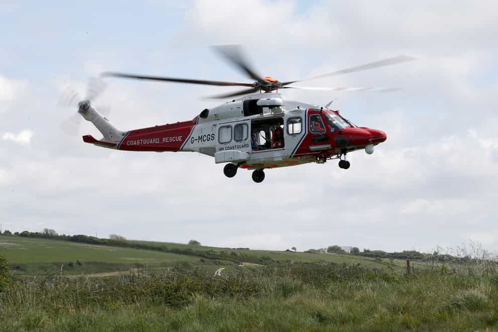 An HM Coastguard helicopter was involved in the rescue effort (Andrew Matthews/PA)