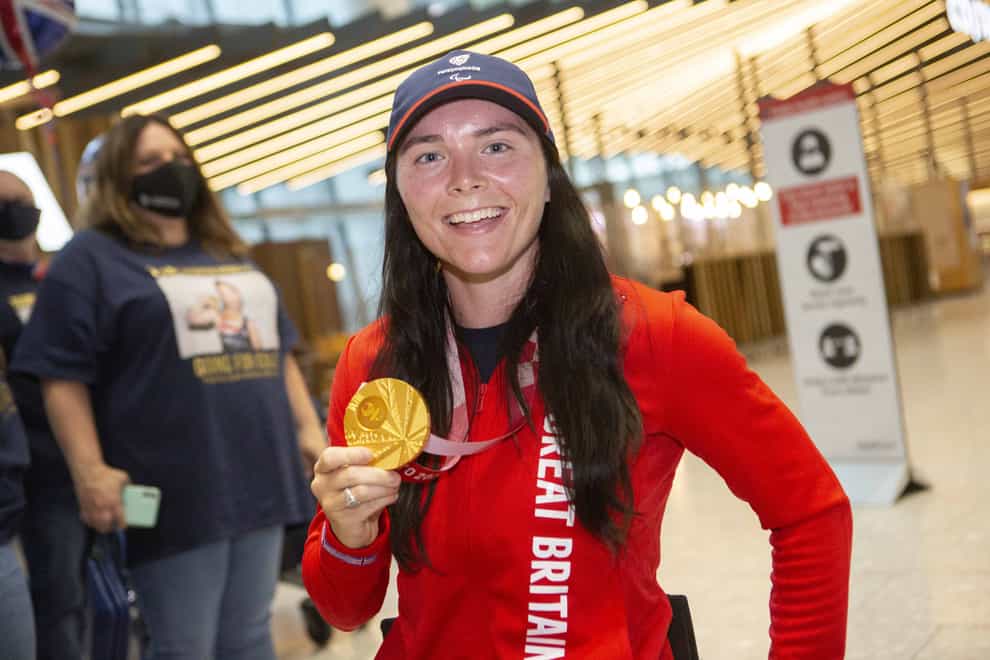 Gold medalist Lauren Rowles arrives back at London Heathrow (Rick Findler/PA)