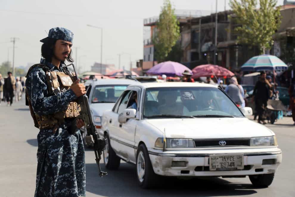 A Taliban fighter stands guard in Kabul, Afghanistan (Wali Sabawoon/AP)