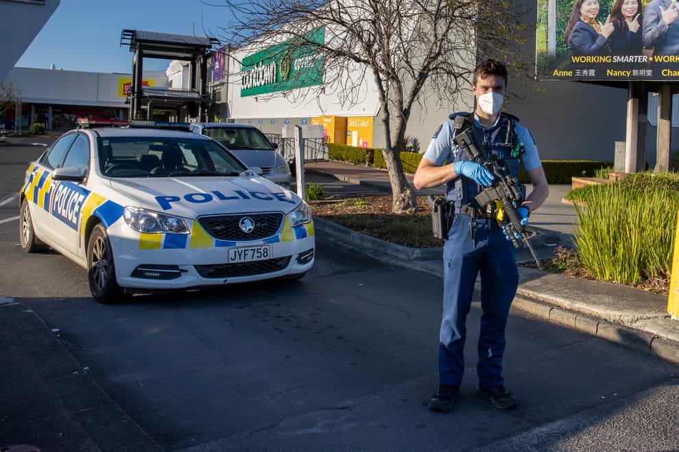 Armed police stand outside the supermarket in Auckland (Brett Phibbs/AP)