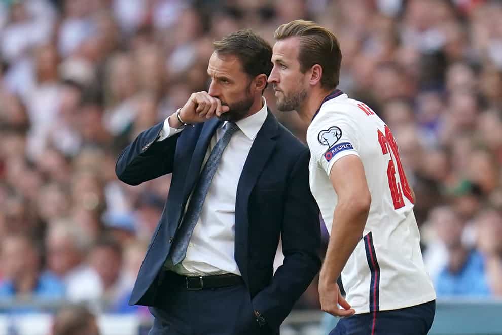 England’s Gareth Southgate speaks with substitute Harry Kane (PA)