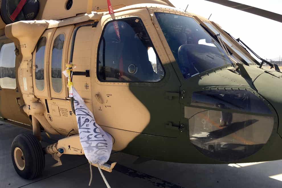 A damaged Afghan military helicopter is seen after the Taliban’s takeover inside the Hamid Karzai International Airport in Kabul, Afghanistan (Mohammad Asif Khan/AP)