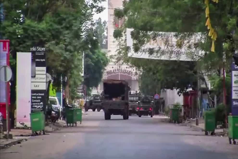 A military vehicle is seen near the presidential palace in the capital Conakry, Guinea (AP)
