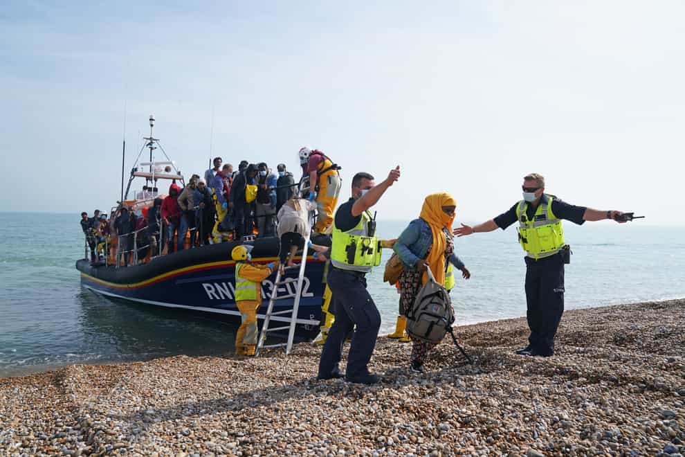 A group of people thought to be migrants are brought ashore from the local lifeboat at Dungeness in Kent, after being picked-up following a small boat incident in the Channel (Gareth Fuller/PA)