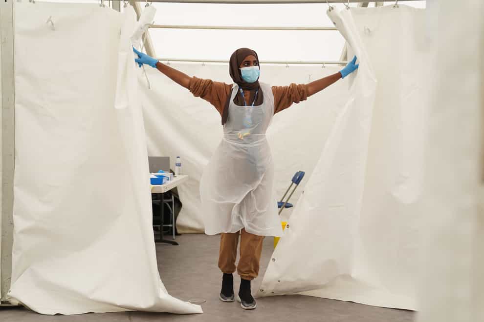 An NHS worker looks for patients at a Covid-19 pop-up vaccination centre in Langdon Park, Poplar, east London (Kirsty O’Connor/PA)