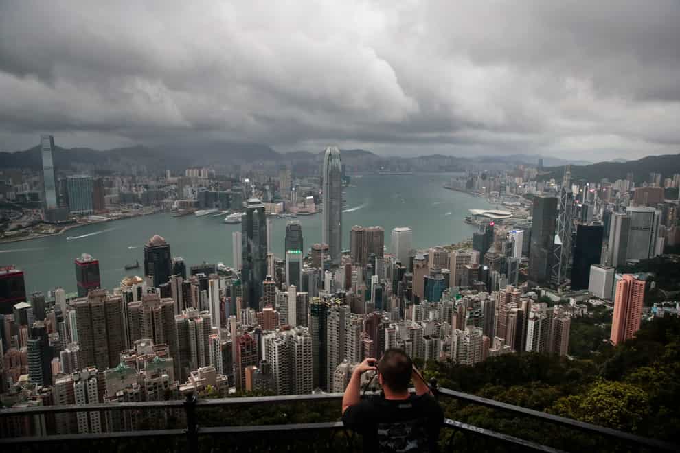 A visitor sets up his camera in the Victoria Peak area to photograph Hong Kong’s skyline (Jae C. Hong/AP)