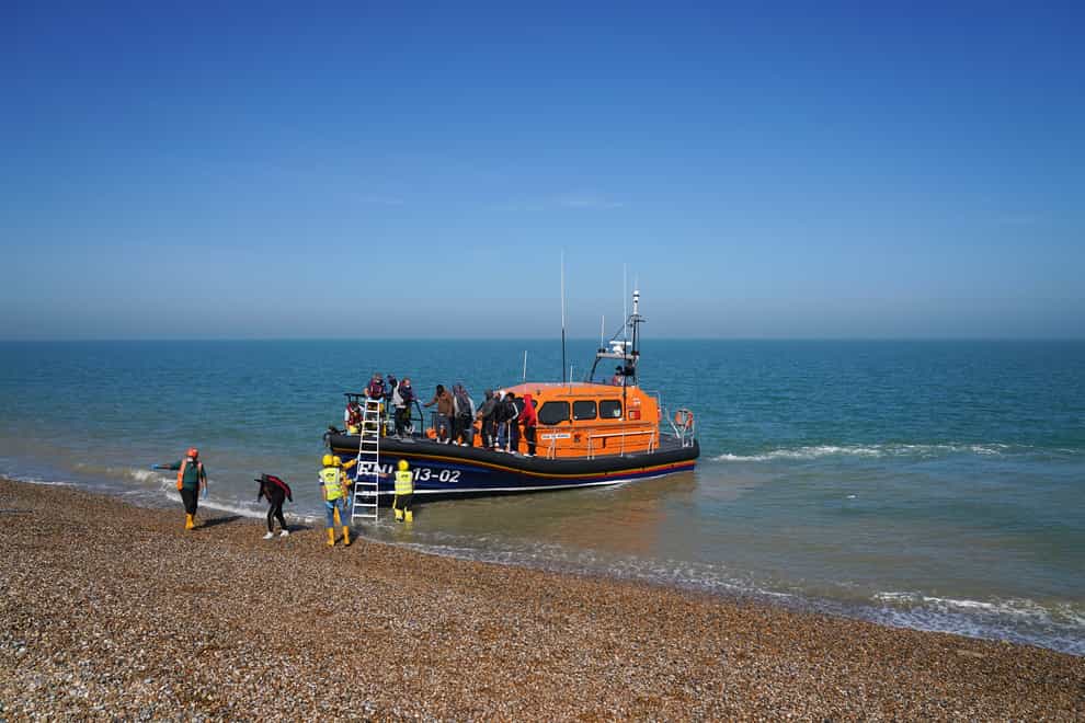 A group of people thought to be migrants are brought ashore from the local lifeboat at Dungeness in Kent (Gareth Fuller/PA)