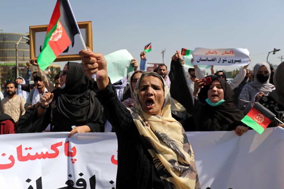 Afghan women shout slogans and wave Afghan national flags during an anti-Pakistan demonstration, near the Pakistan embassy (AP)