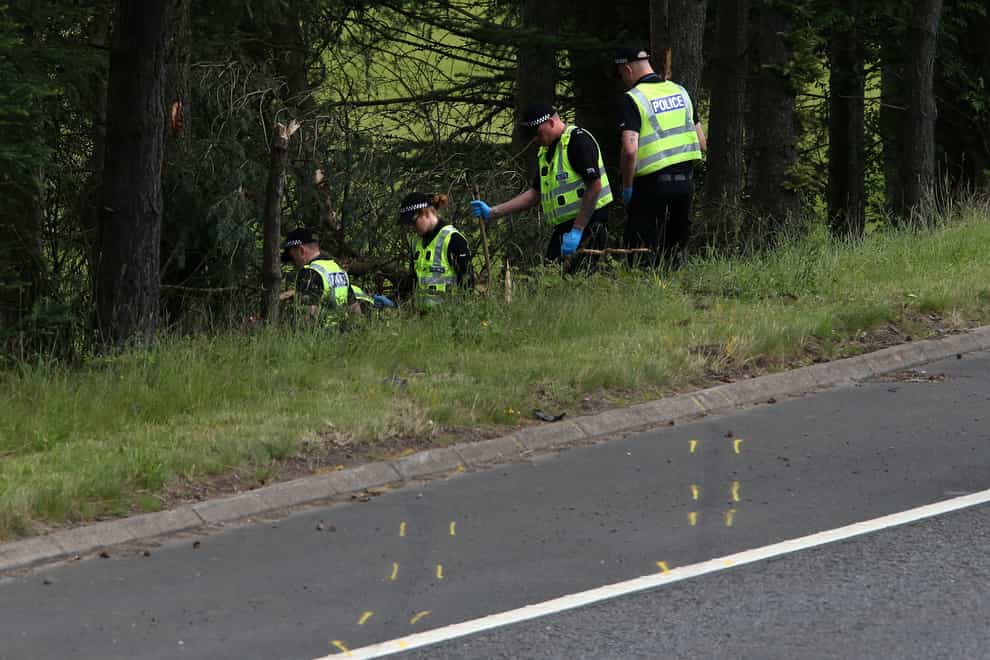 Police officers at the site of the crash on the M9 near Stirling (Andrew Milligan/PA)