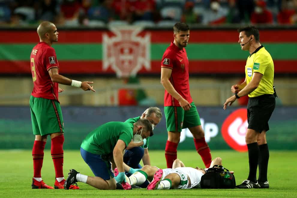 Republic of Ireland defender Dara O’Shea receives treatment on the pitch in Portugal (Isabel Infantes/PA)